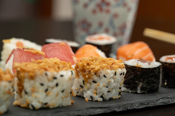 Japanese sushi food. Maki ands rolls with tuna, salmon, shrimp, crab and avocado. Close up and top view of assorted sushi. 