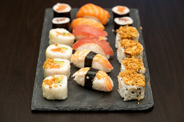 Japanese sushi food. Maki ands rolls with tuna, salmon, shrimp, crab and avocado. Close up and top view of assorted sushi. 