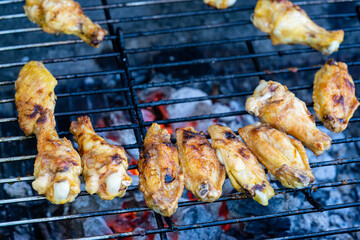 Delicious chicken wings barbecue on hot grill. Close up