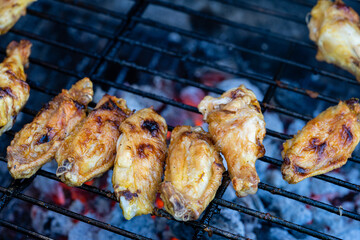 Delicious chicken wings barbecue on hot grill. Close up
