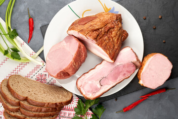 Assortment of meat products with lard on a platter without slicing. Still life of ham.