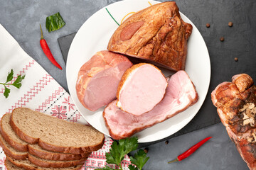 Assortment of meat delicacies on a platter without slicing.