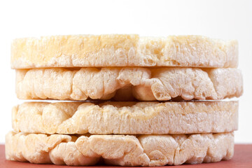 Round crispy crispbread on a pink background. Round cereal bread, healthy diet without yeast. coarse flour flakes for diet.
