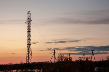 Sundown and sunrises. Blue sky with tints of purple and much clouds. Silhouettes of trees and grass are reflectioning in the river water. Background of heaven. Beautiful evening