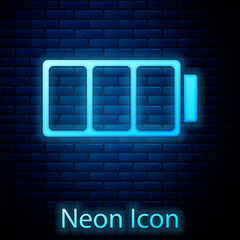 Glowing neon Battery charge level indicator icon isolated on brick wall background. Vector.
