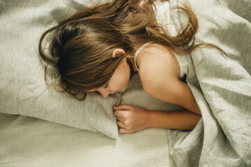 teenage girl sleeping on the bed