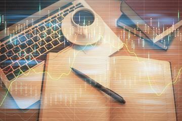 Stock market graph and top view computer on the table background. Multi exposure. Concept of financial education.