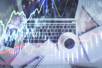 Stock market chart and top view computer on the table background. Double exposure. Concept of financial analysis.