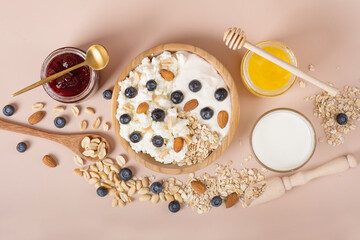 Yogurt with granola and fresh blueberries, in glass bowl