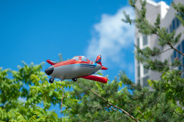 Toy inflatable plane flying over the trees