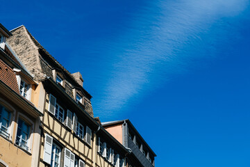 Low angle view of French alsatian timbered house architecture with clear blue sky in between them