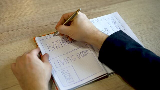 man drawing the plan of the house.