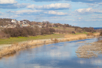 Rural landscape with bright blue sky reflected in the river Samara.