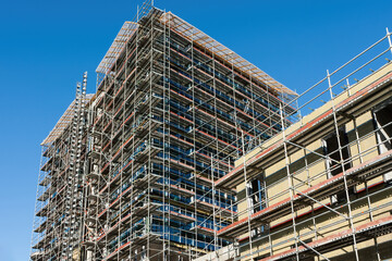 Building under construction with scaffolds.
