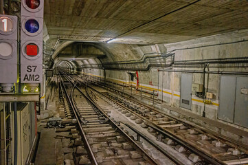 Fototapeta na wymiar Underground tunnel for the subway leading deep down. Tube metro perspective view. Railway transport