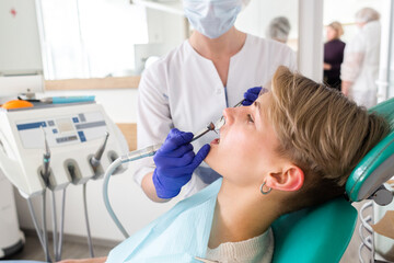 Woman at the dentist consultation. Checking and dental treatment in a clinic