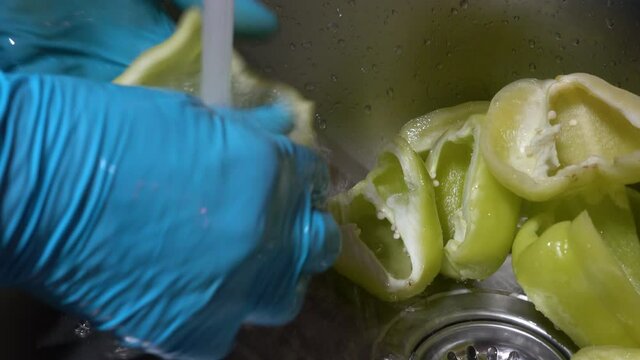 Washing peppers in running water - (4K)