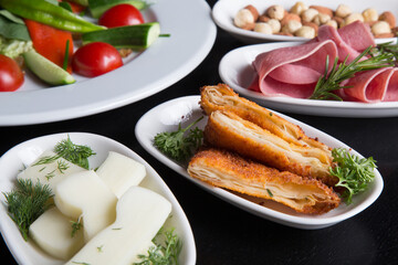 Fried pastry on a breakfast table black background
