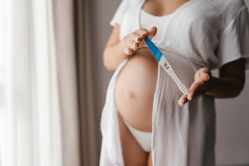 Obraz na płótnie Canvas Pregnant Woman holding pregnancy test, New life and new family concept.