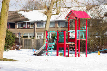 Play set with slide in residential area in the winter with snow