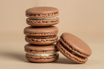 Brown homemade macarons, on a brown background