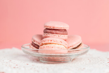 Pink homemade macarons on a pink background