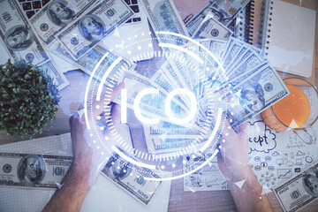 Multi exposure of blockchain theme drawing hologram and USA dollars bills and man hands. Business concept.