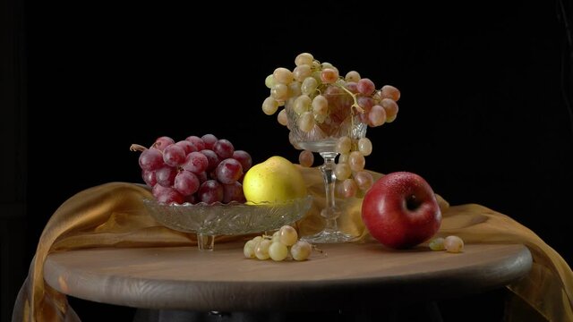 Apples and grapes on a black background.