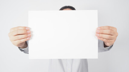 Man hold blank empty paper and wear shirt on white background.asian people