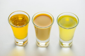 Fresh organic apple cider with apples and cinnamon over white background. Close up three glasses.