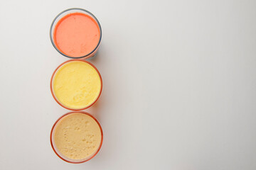 Isolated citrus juice. One glass with orange, grapefruit or lemon juice isolated on white background.