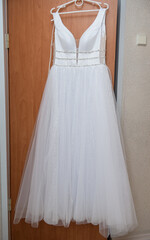 Fototapeta na wymiar Bride's dress. White dress. Grooming dress White dress in the center of the room.