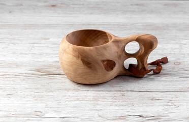 Traditional Sami wooden cups on a wooden table. Kuksa. Finnish wooden cups. Finnish culture.
