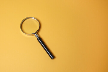 A magnifying glass isolated on the yellow background