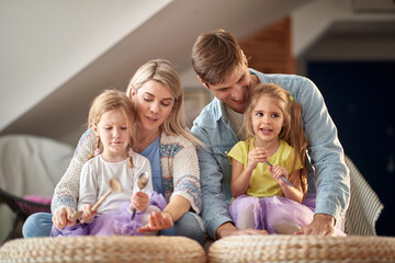 Parents playing together with their children