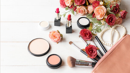Fototapeta na wymiar Valentine Gift. Makeup cosmetics tools background and beauty cosmetics, products and facial cosmetics package with flower rose and Pearl necklace. 