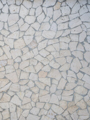 The wall is lined with light decorative tiles of various shapes. Full screen photo. Not seamless texture