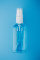 antiseptic on a blue background, sanitizer in medicine protection against viruses and bacteria. small and comfortable