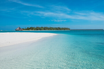 turquoise water and white sand beach on the island of dhiffushi, maldives. 