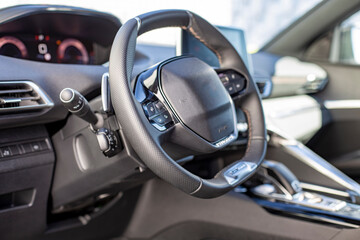 empty interior of driver's seat and steering wheel of a modern fashionable car