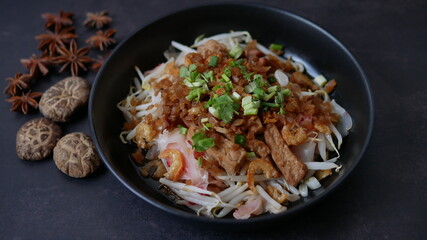 Rice flat noodle with dried shrimp,  ground pork, squid, tofu and beansprout in sweet black soy sauce, Thai called Kuay Teow Lord