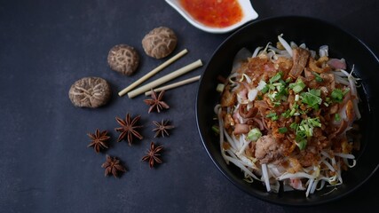 Rice flat noodle with dried shrimp,  ground pork, squid, tofu and beansprout in sweet black soy sauce, Thai called Kuay Teow Lord