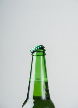 Macro photo of the neck of an open beer bottle