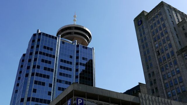 Modern business building and Vancouver lookout tower in downtown Vancouver BC Canada.