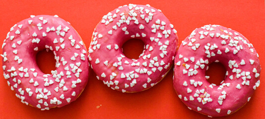Baked donuts on red background