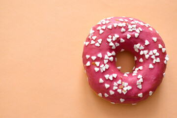 Baked donut on orange background