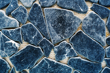 Decorative stone for wall cladding. Samples of material of different shapes and sizes in cold colors. Flat lay frame