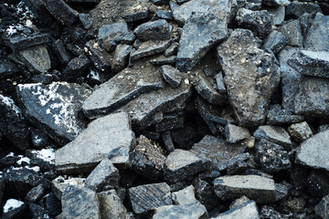 Broken asphalt pavement. Clearing and preparation of the territory for the construction of a new highway. Close-up