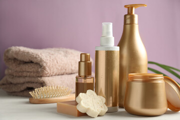 Composition with hair care cosmetic products on white table. Space for text