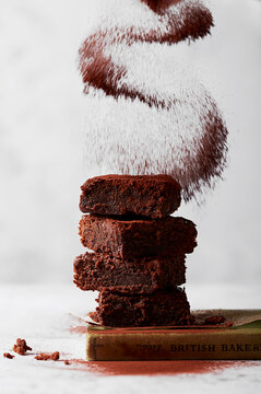 Brownies stacked with cocoa powder dusting
